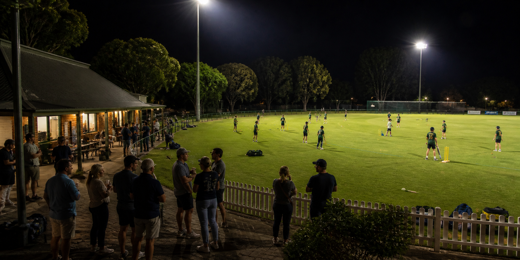 Community gathering around a local sports ground at night
